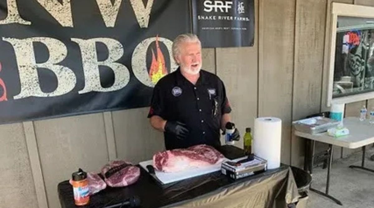 Myron Mixon Net Worth 2026 – BBQ champion preparing meat at cooking demonstration