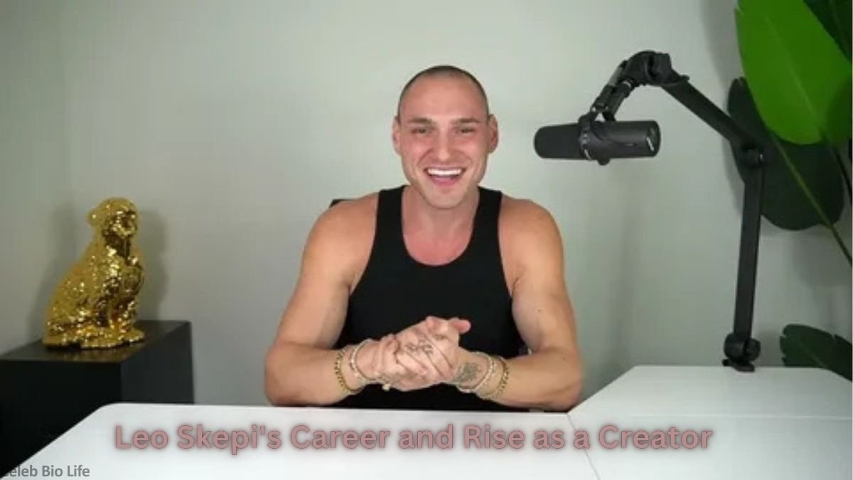 Smiling man sitting at a desk with a microphone
