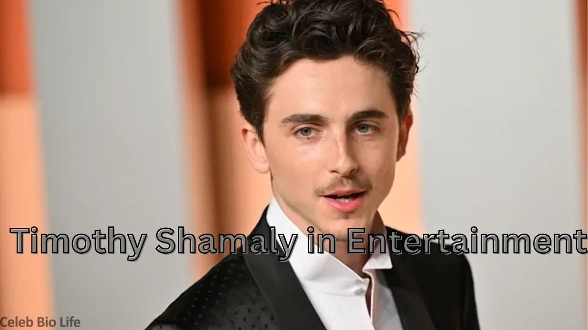 Young actor in black suit portrait.