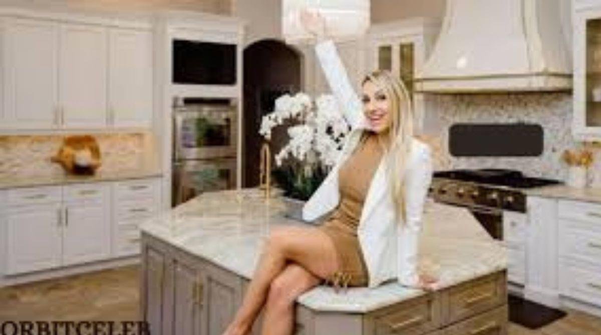 Amanda Ivanelli sitting in a luxury kitchen wearing a stylish outfit, Amanda Ivanelli net worth reflected through luxury lifestyle